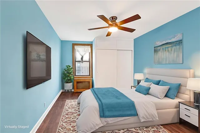 a bedroom with a bed and a painting on the wall