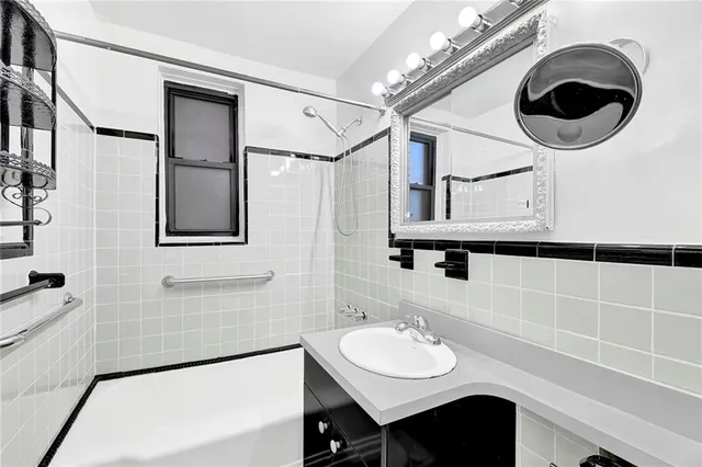a bathroom with a sink a mirror and a shower