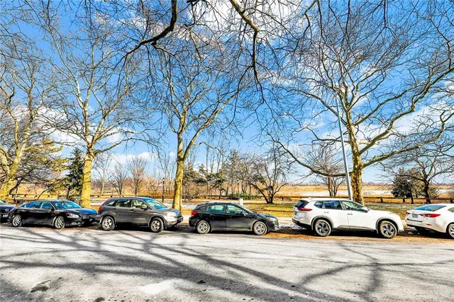 a view of cars parked on the side of a street