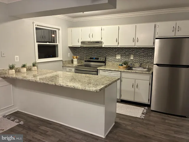 a kitchen with a sink a stove and refrigerator