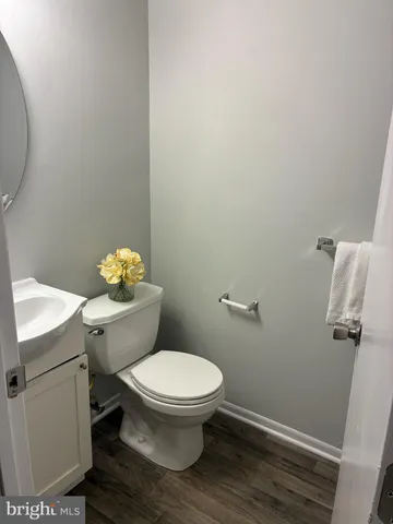 a white toilet sitting next to a bathroom sink
