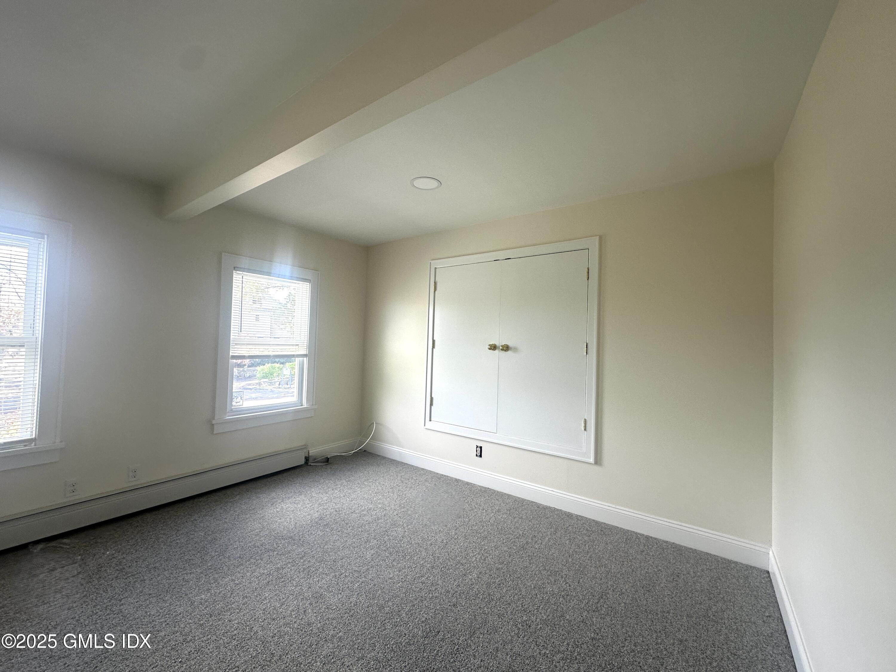 85 Strickland Road, Unit 2 Cos Cob, CT 06807 - Photo 11 of 26 an empty room with a window