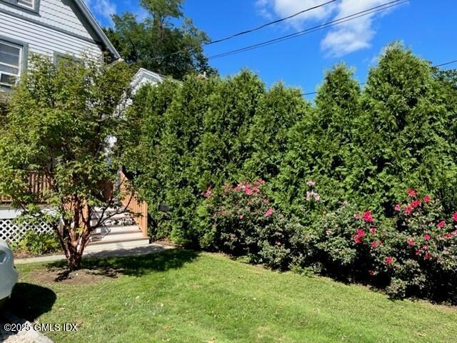 85 Strickland Road, Unit 2 Cos Cob, CT 06807 - Photo 19 of 26 a view of a garden with flowers and trees