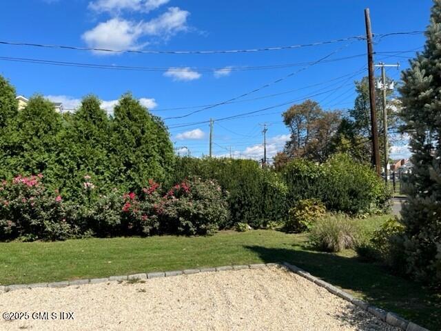85 Strickland Road, Unit 2 Cos Cob, CT 06807 - Photo 20 of 26 a view of a yard and front view of a house