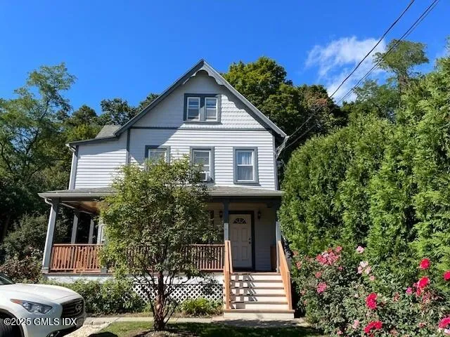 a front view of a house with a garden