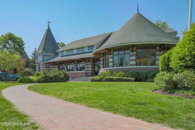 a front view of a house with a garden