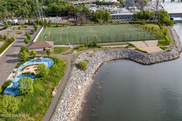an aerial view of a house with a yard basket ball court and outdoor seating