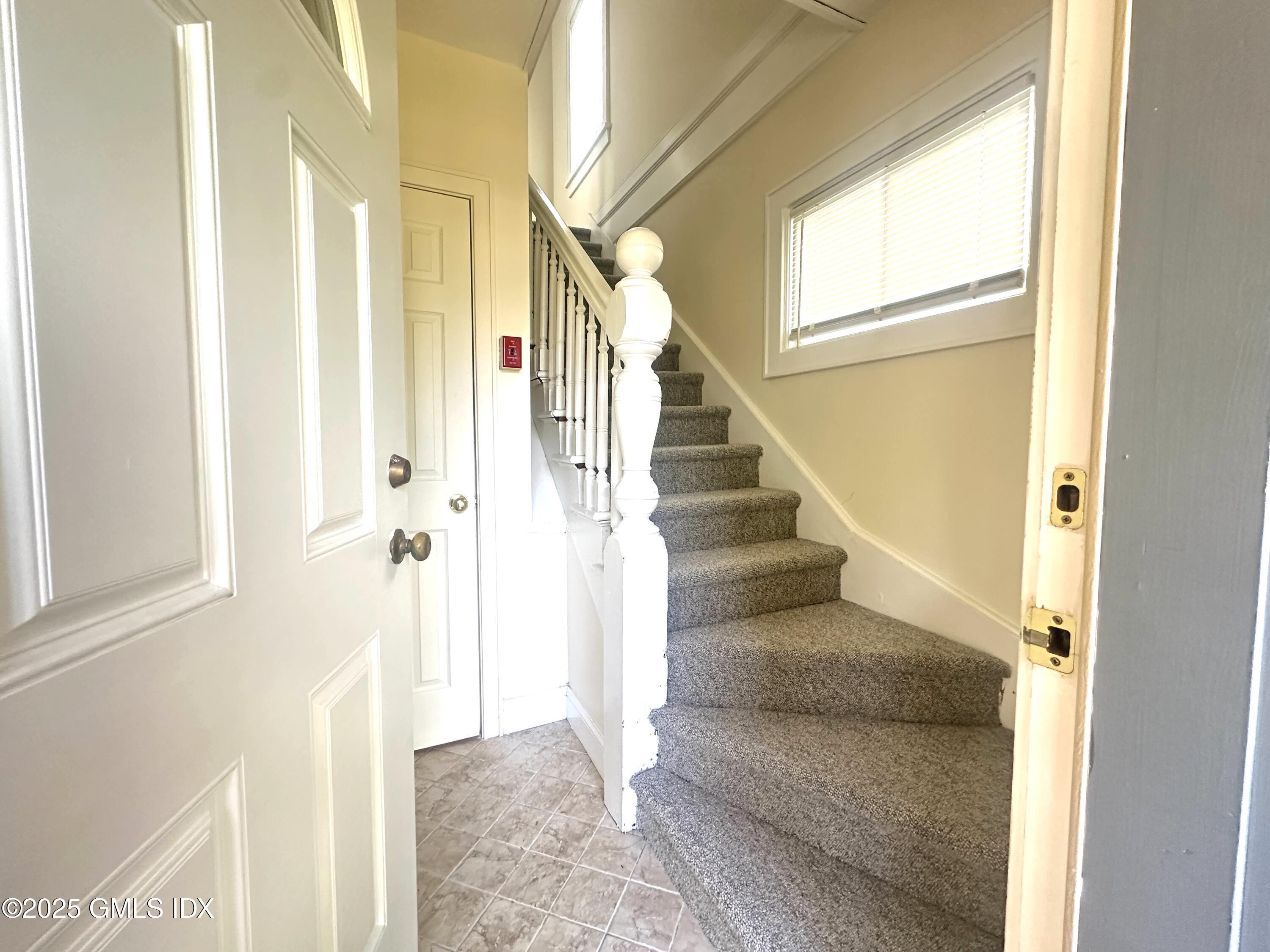 85 Strickland Road, Unit 2 Cos Cob, CT 06807 - Photo 3 of 26 a view of entryway and hall with wooden floor