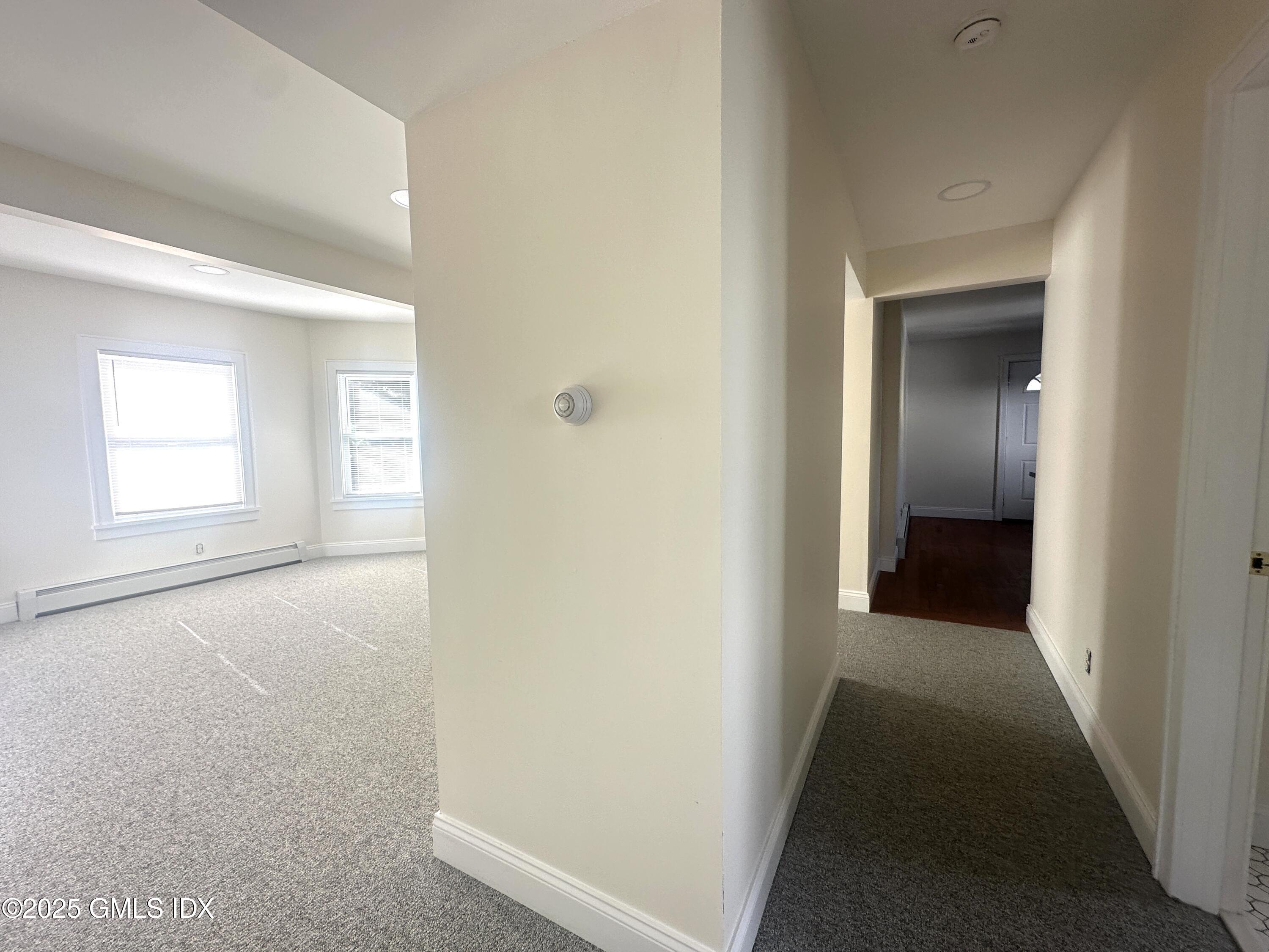 85 Strickland Road, Unit 2 Cos Cob, CT 06807 - Photo 6 of 26 a view of hallway with windows