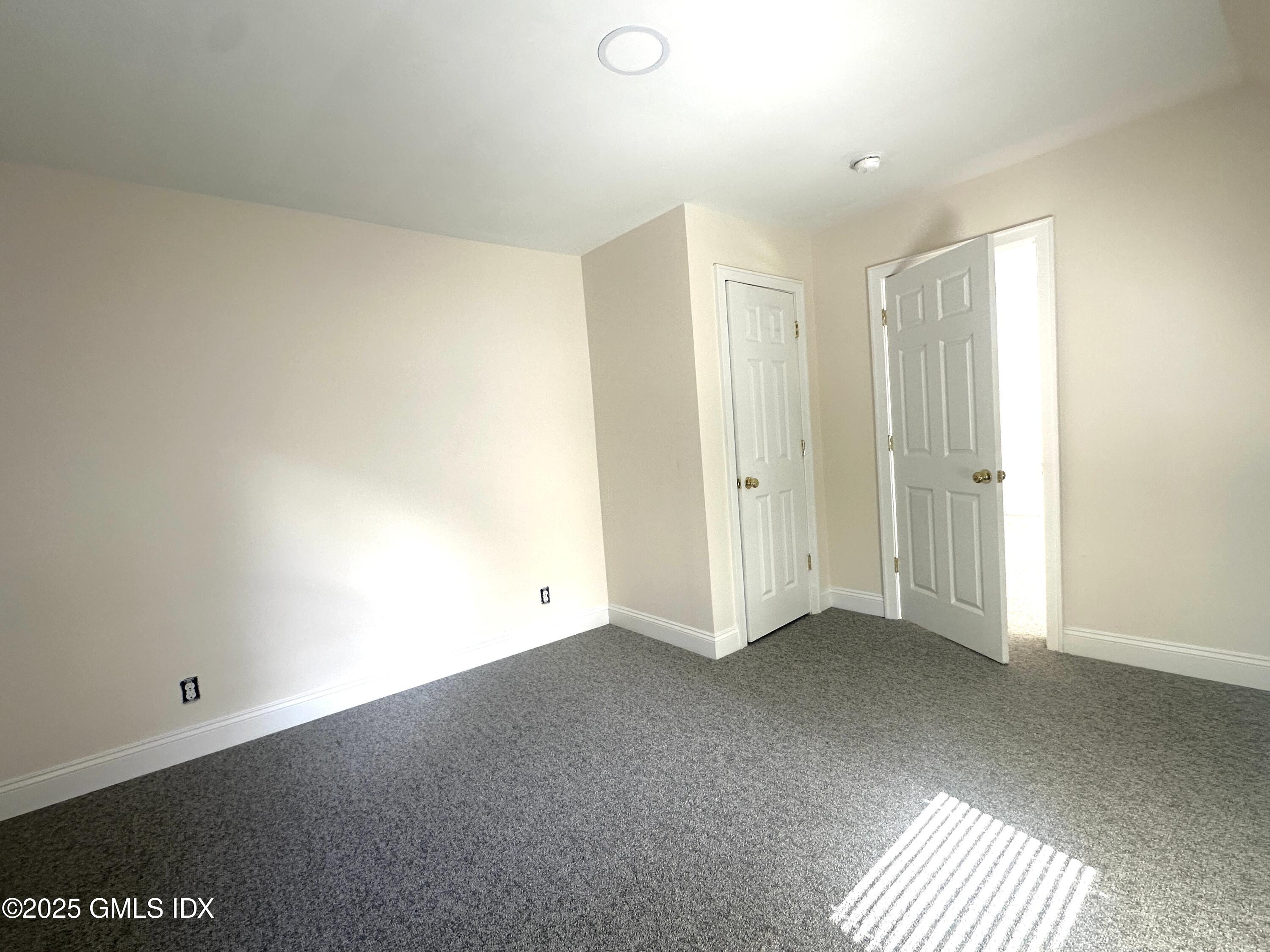 85 Strickland Road, Unit 2 Cos Cob, CT 06807 - Photo 9 of 26 an empty room with windows