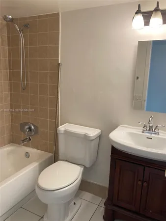 a bathroom with a sink a toilet and bathtub