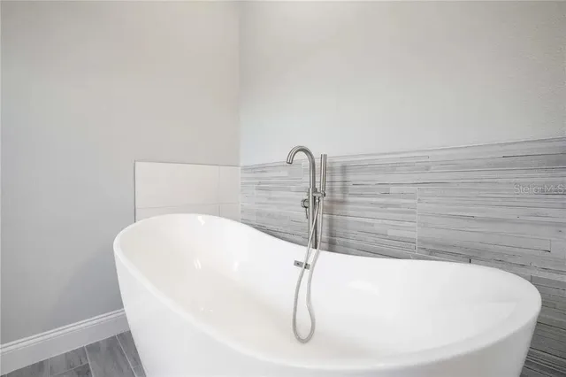a white bath tub sitting in a bathroom