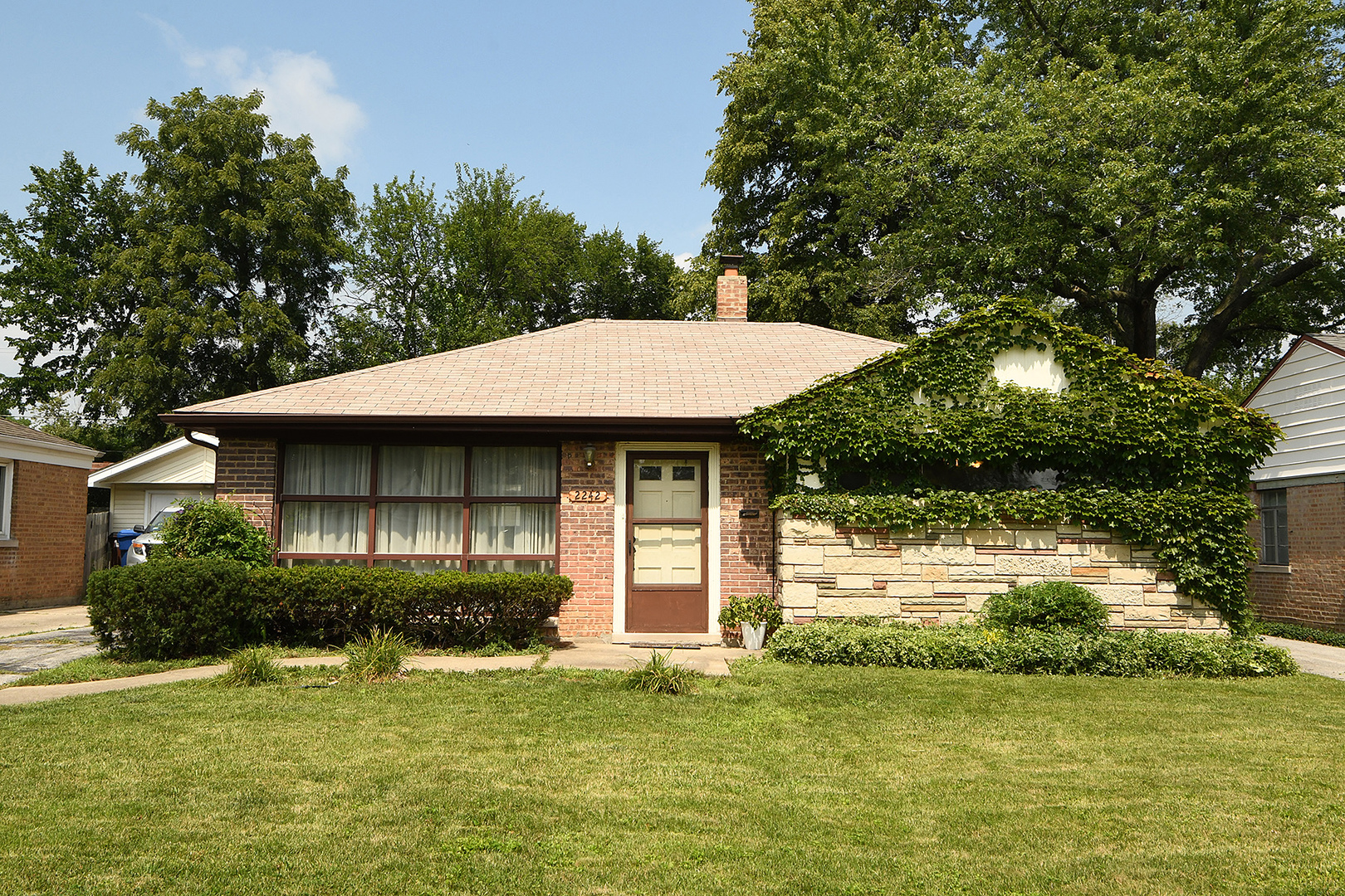 a front view of a house with a yard garage and outdoor seating
