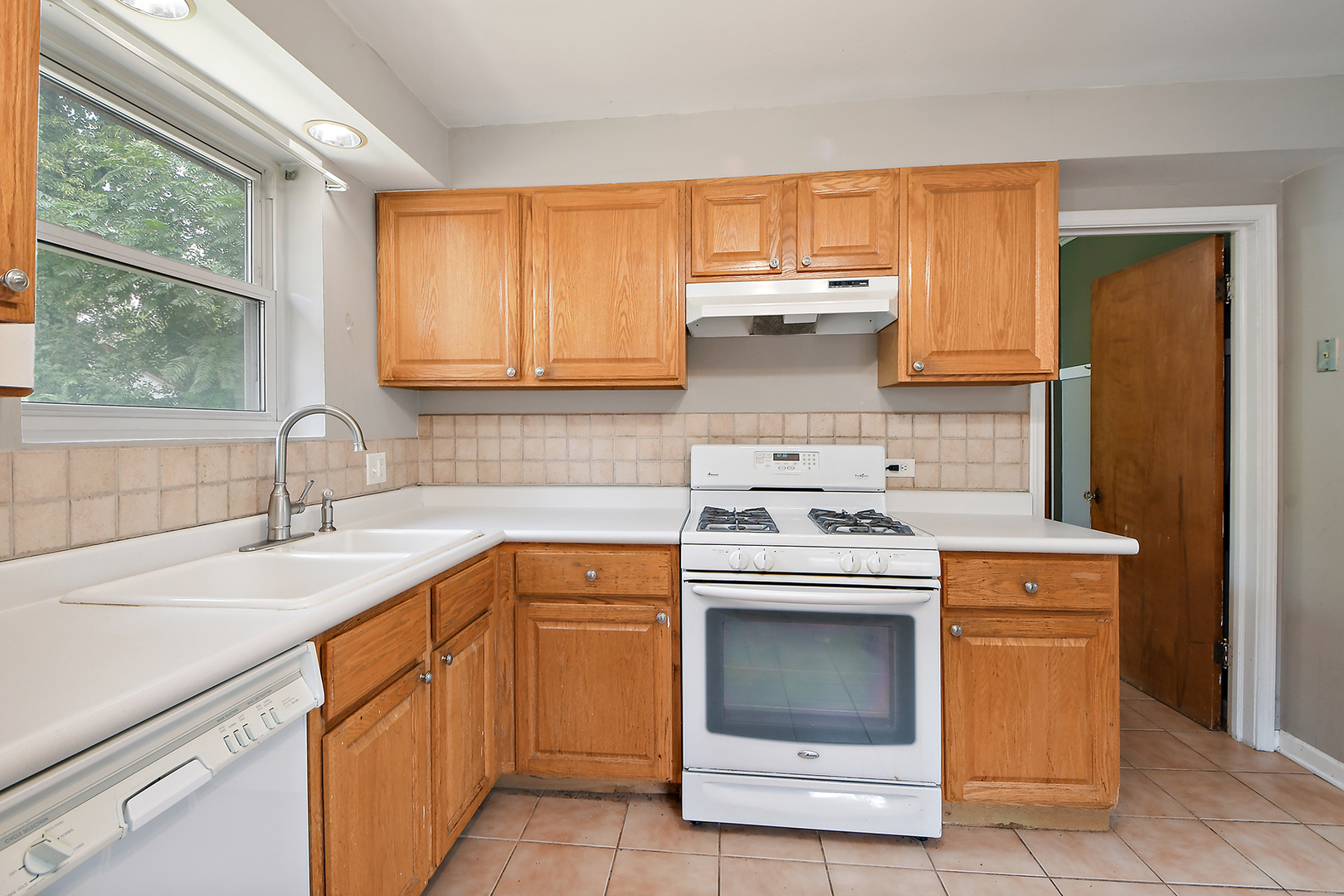2242 Spruce Road Homewood, IL 60430 - Photo 3 of 15 a kitchen with a stove sink and cabinets