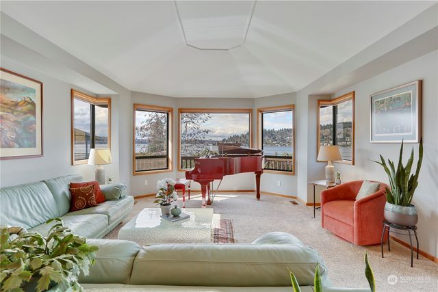 a living room with furniture and floor to ceiling windows