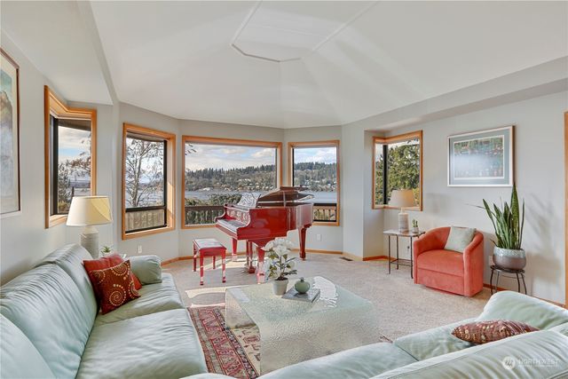 a living room with furniture and floor to ceiling windows