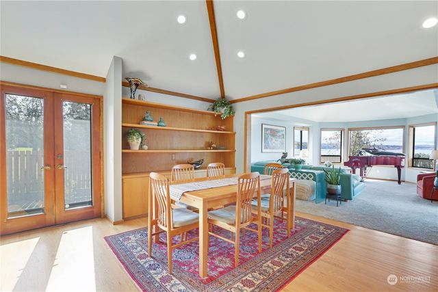 a dining room with furniture and a floor to ceiling window