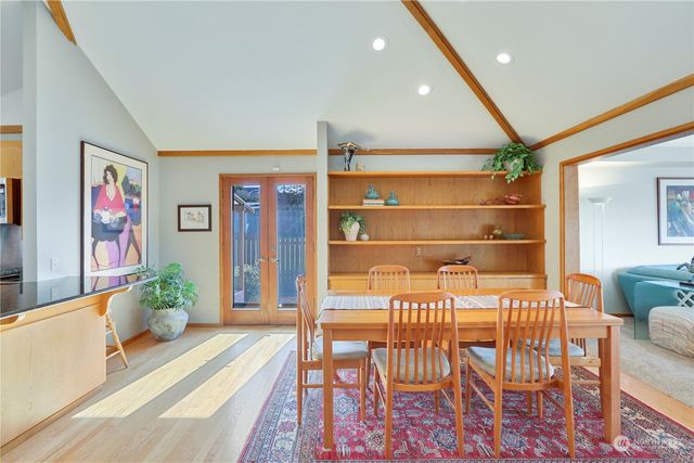 a hallway with a dining table and chairs