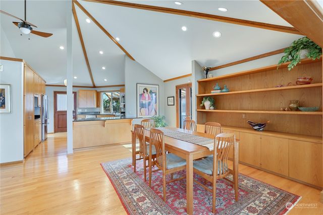 a dining room with wooden floor and a rug