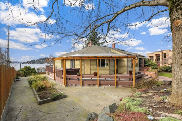 a patio with sofas table and chairs