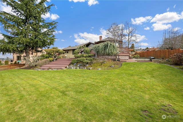 a backyard of a house with table and chairs