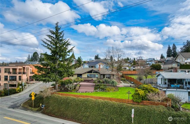 an aerial view of a house with a yard basket ball court and outdoor seating