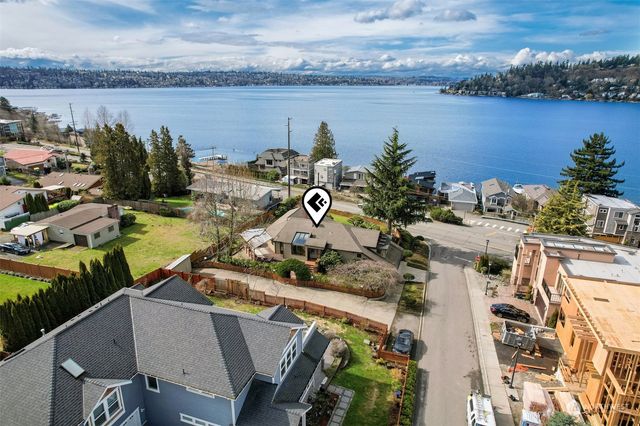 an aerial view of a house with a garden and swimming pool
