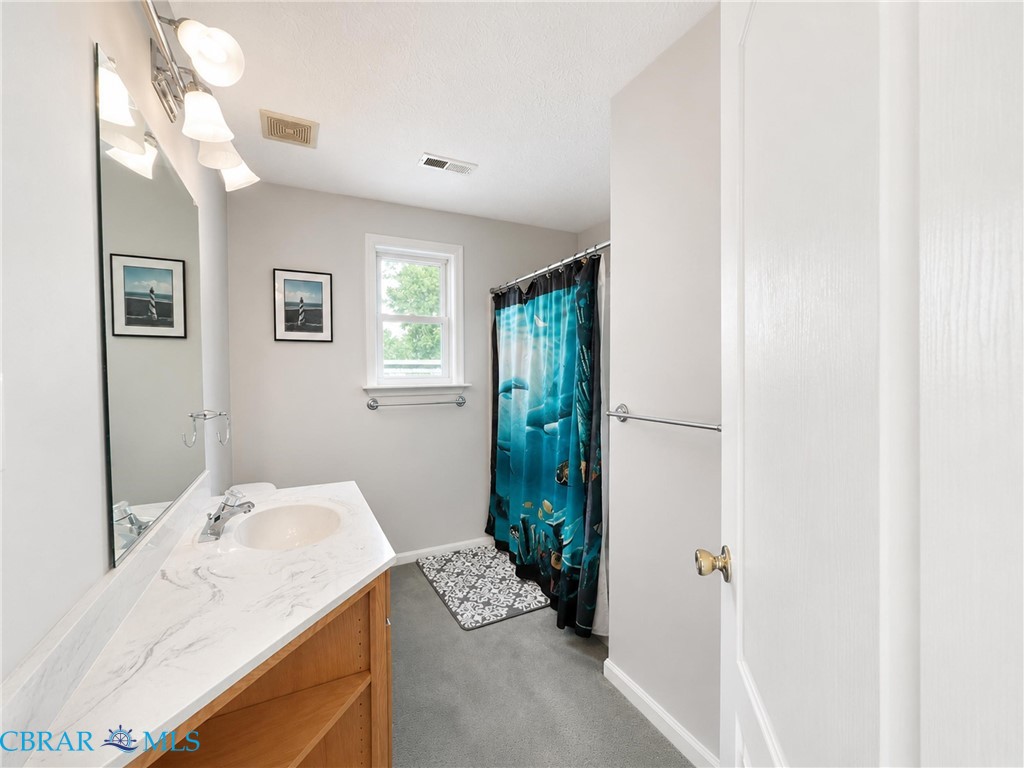 1214 Dandy Loop Road Yorktown, VA 23692 - Photo 55 of 65 a en suite bathroom with a granite countertop sink and a mirror