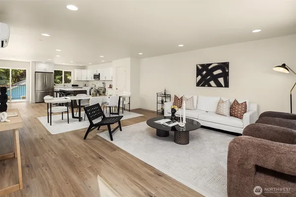 a living room with furniture and kitchen view