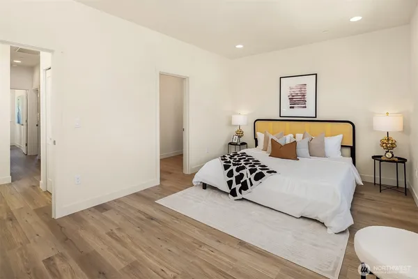 a bedroom with a bed and wooden floor