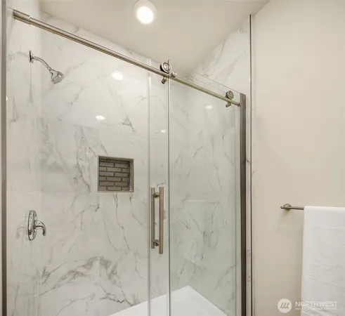 a bathroom with a shower and a glass door
