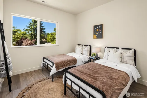 a bedroom with two beds and a window