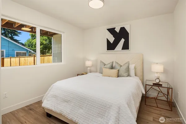 a bedroom with a bed and a painting on the wall