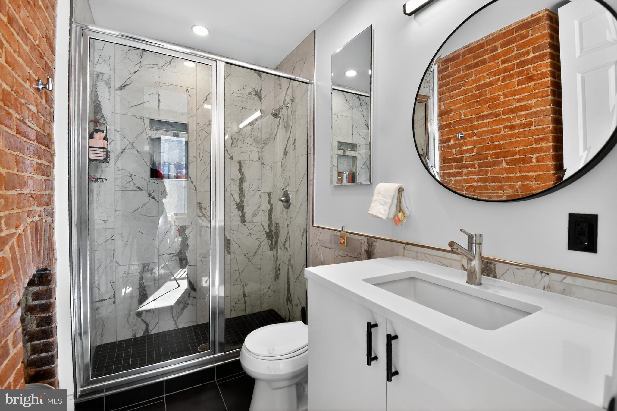 459 Massachusetts Avenue Northwest, Unit 24 Washington, DC 20001 - Photo 11 of 18 a bathroom with a sink toilet and shower