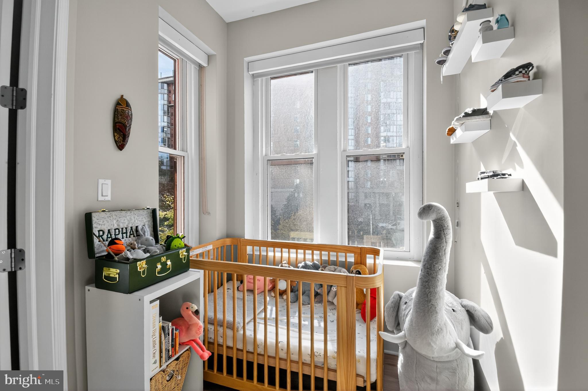 459 Massachusetts Avenue Northwest, Unit 24 Washington, DC 20001 - Photo 12 of 18 a bedroom with furniture and a window