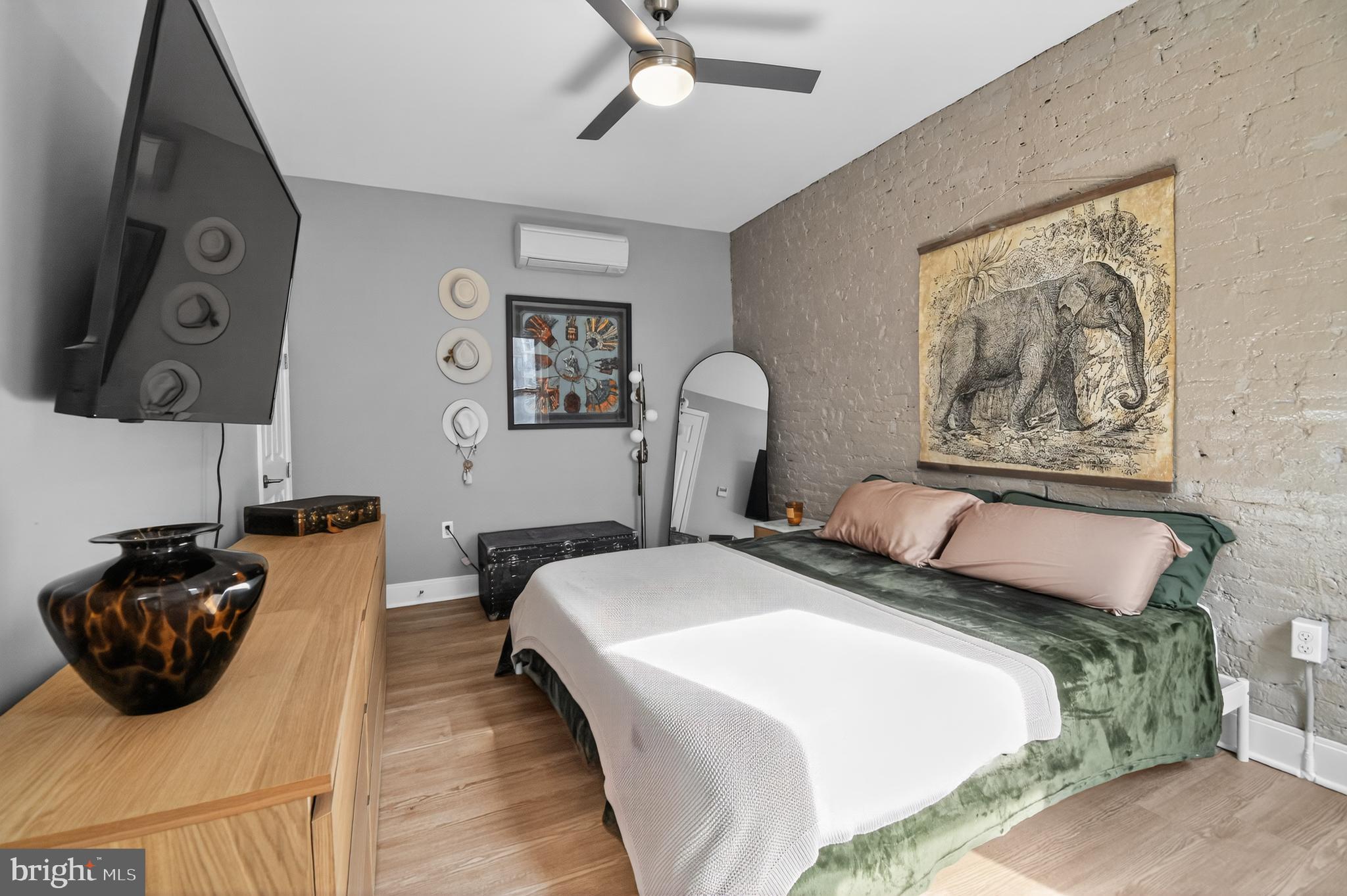 459 Massachusetts Avenue Northwest, Unit 24 Washington, DC 20001 - Photo 13 of 18 a bedroom with a bed and dresser