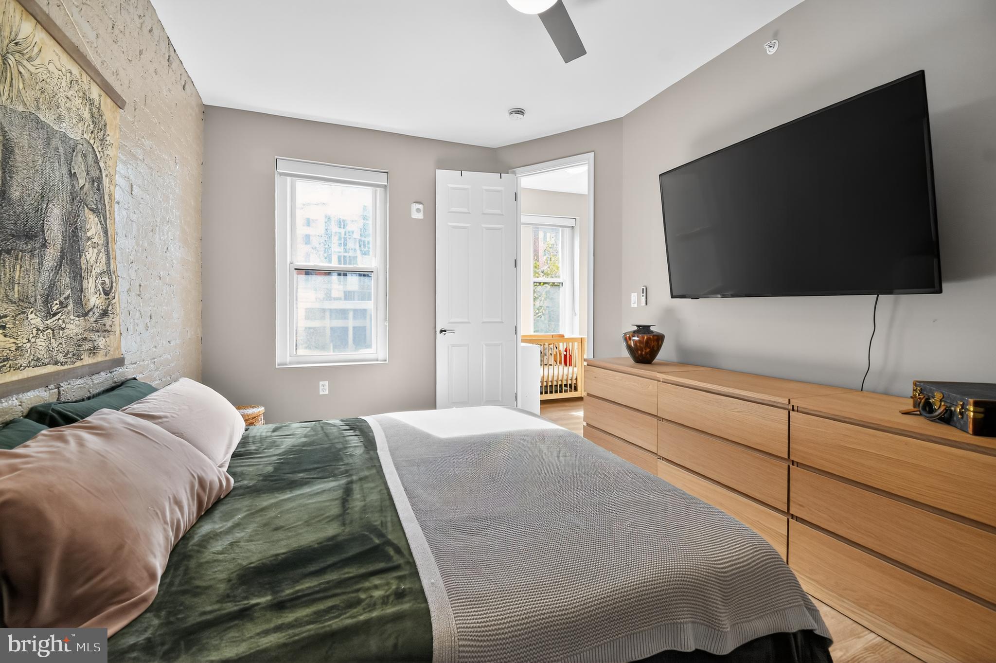 459 Massachusetts Avenue Northwest, Unit 24 Washington, DC 20001 - Photo 15 of 18 a bedroom with a bed a flat screen tv and a window