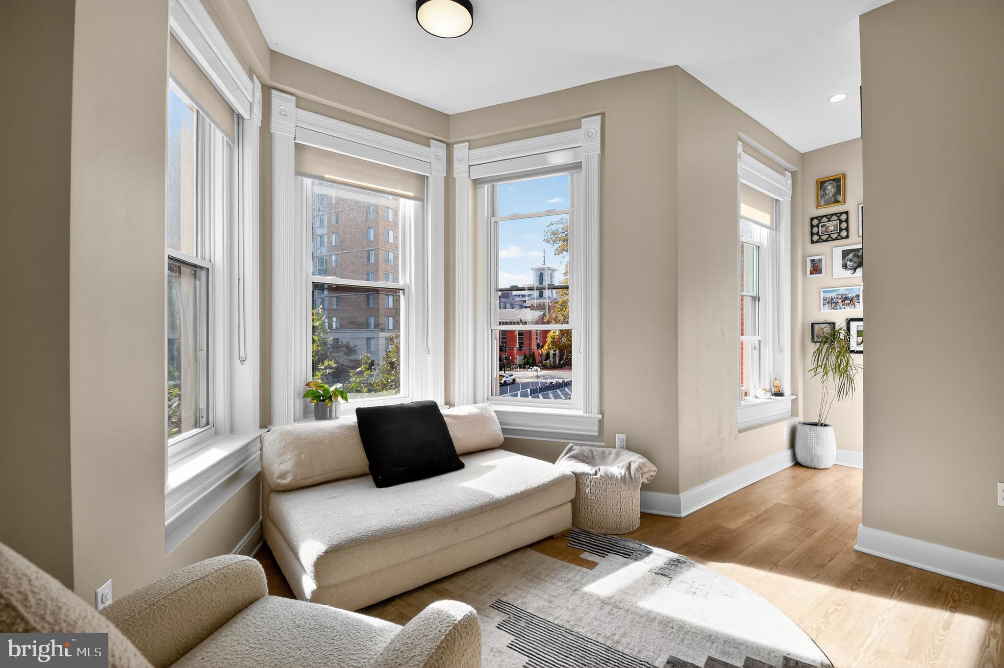 459 Massachusetts Avenue Northwest, Unit 24 Washington, DC 20001 - Photo 3 of 18 a living room with furniture and a large window