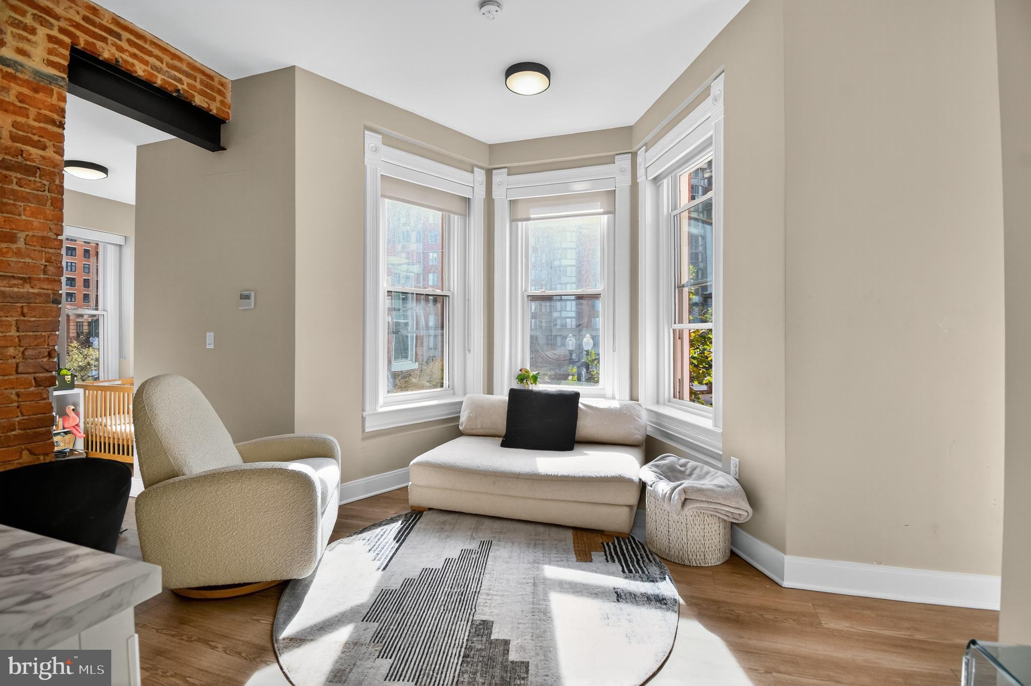 459 Massachusetts Avenue Northwest, Unit 24 Washington, DC 20001 - Photo 5 of 18 a living room with furniture and a window
