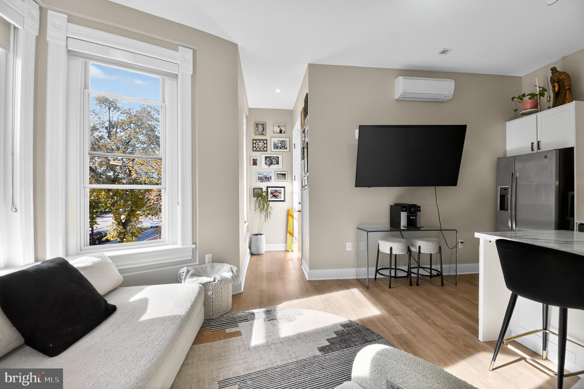 459 Massachusetts Avenue Northwest, Unit 24 Washington, DC 20001 - Photo 6 of 18 a living room with furniture and a flat screen tv