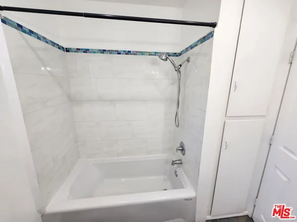 a bathroom with a shower and a bath tub