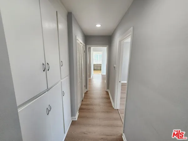 a view of a hallway with wooden floor and staircase