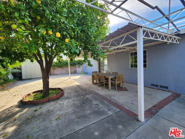 a view of a patio with table and chairs