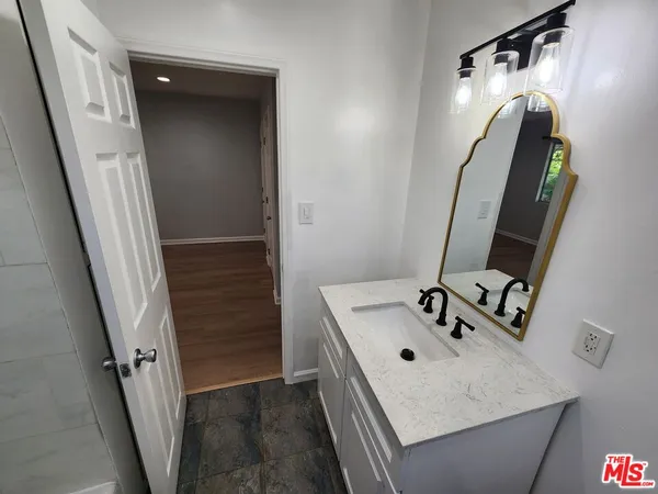 a bathroom with a sink a mirror and vanity