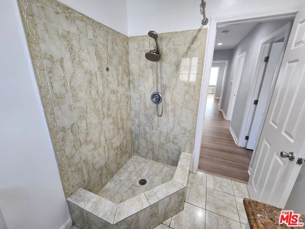 a bathroom with a shower and a tub