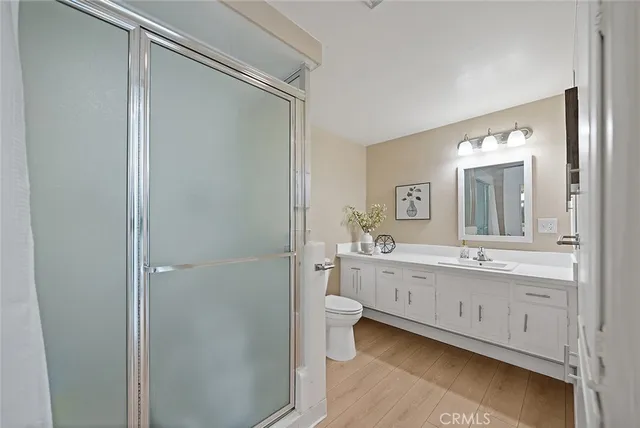 a bathroom with a double vanity sink and mirror with shower