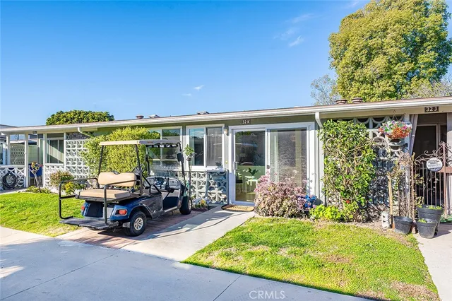 a view of a house with backyard sitting area and garden