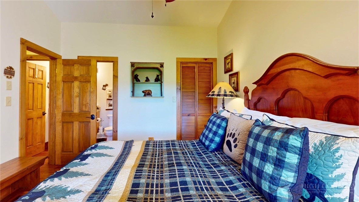 250 Ridgeview Road, Unit 43 Sugar Mountain, NC 28604 - Photo 17 of 21 a bedroom with a bed and wooden floor