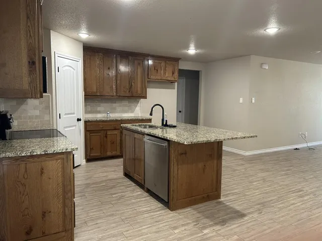 a kitchen with sink and cabinets