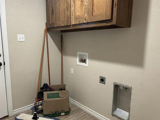 a view of storage and utility room with wooden floor